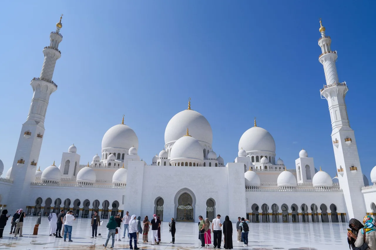 Co si obléct do Dubaje: dress code na ulici, do mešity i na pláž Návštěvníci v zahalujícím oblečení procházejí nádvořím Sheikh Zayed Grand Mosque v Abú Zabí